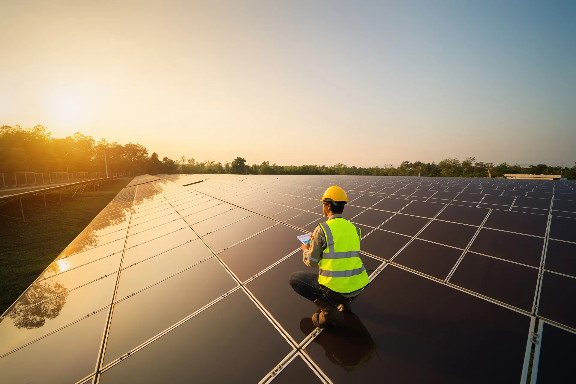 Photograph of an engineer inspecting solar panels